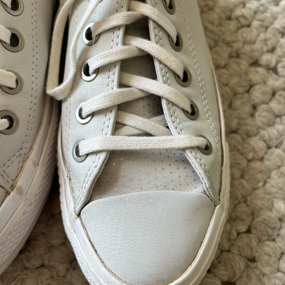 Converse Chuck Taylor All Star Lift Low Top platform sneakers in soft grey.